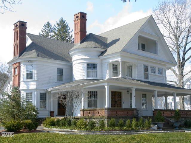 305 Main Street Ridgefield, CT 06877 - Photo 1 of 1 a front view of a house with a garden and plants
