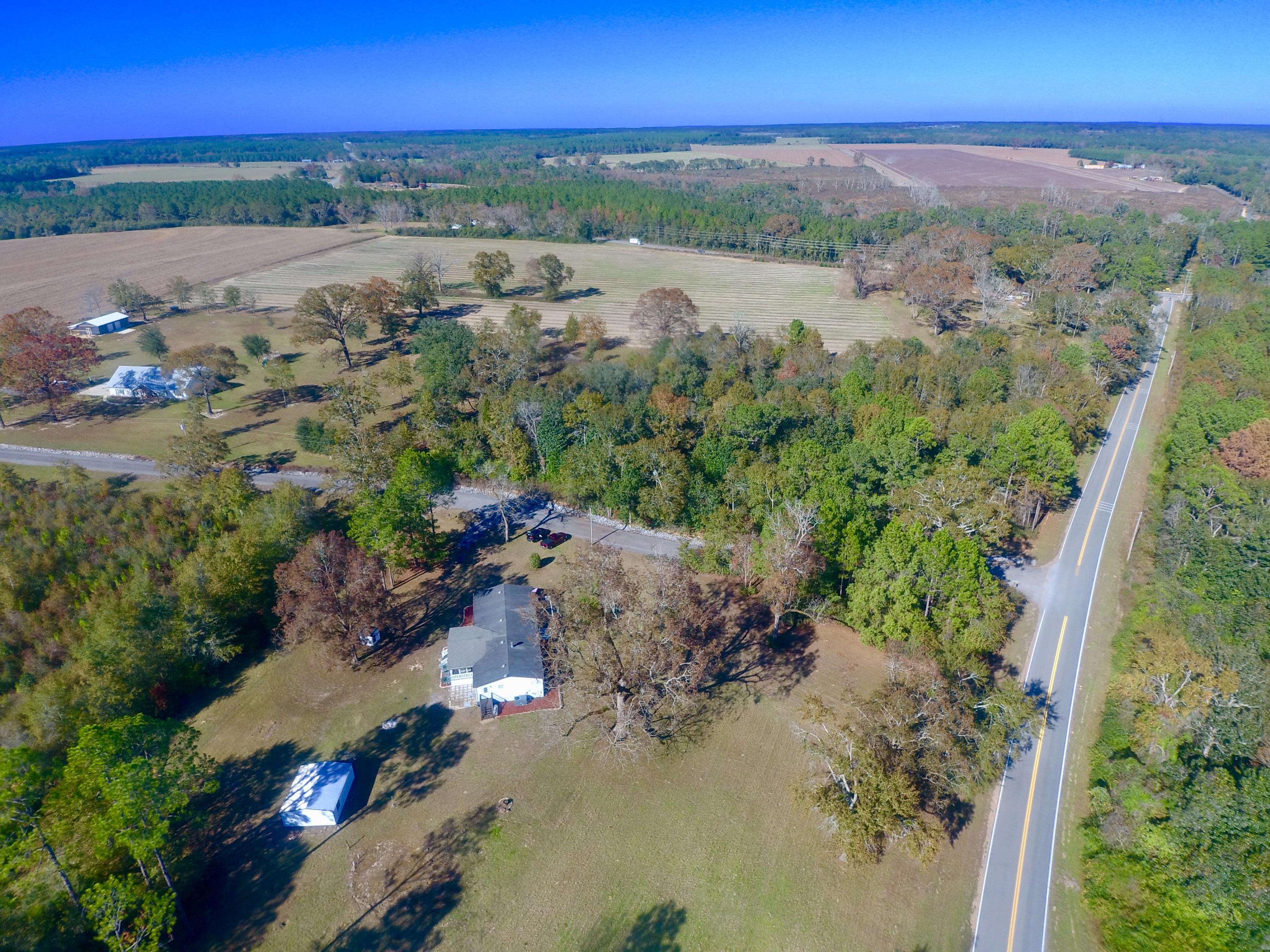 71 Howard Jones Road DeFuniak Springs, FL 32433 - Photo 1 of 32 an aerial view of a city with lots of residential buildings ocean and mountain view in back