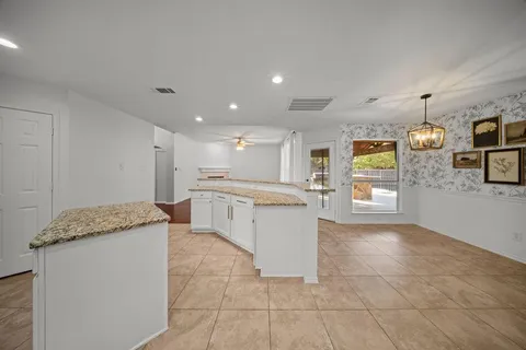 a kitchen with stainless steel appliances granite countertop a sink and a stove