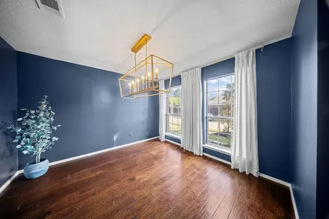 a view of a room with wooden floor