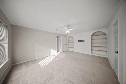 an empty room with windows and closet