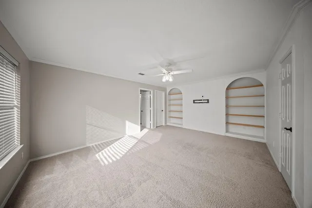 an empty room with windows and closet