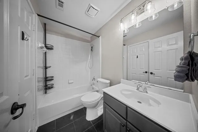 a bathroom with a sink a toilet a mirror and shower