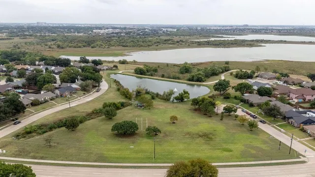 an aerial view of residential houses with outdoor space