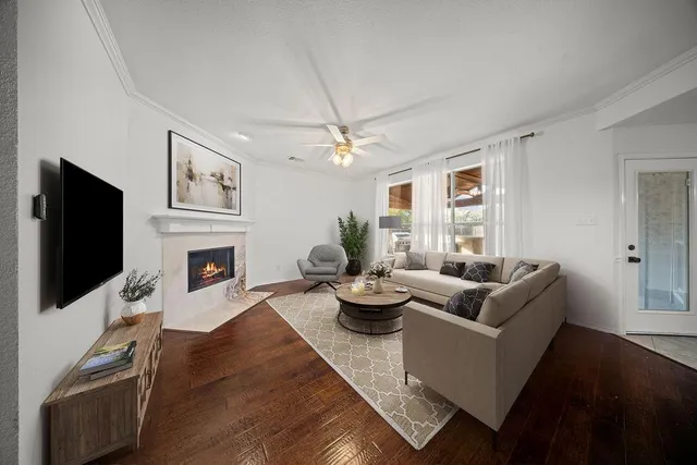 a living room with fireplace furniture and a flat screen tv