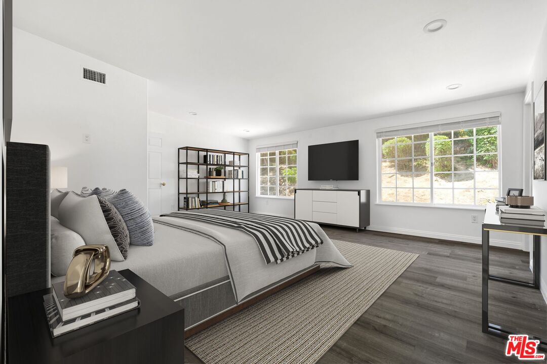 18657 Kirkcolm Lane Porter Ranch, CA 91326 - Photo 12 of 22 a bed room with a bed tv and a chair