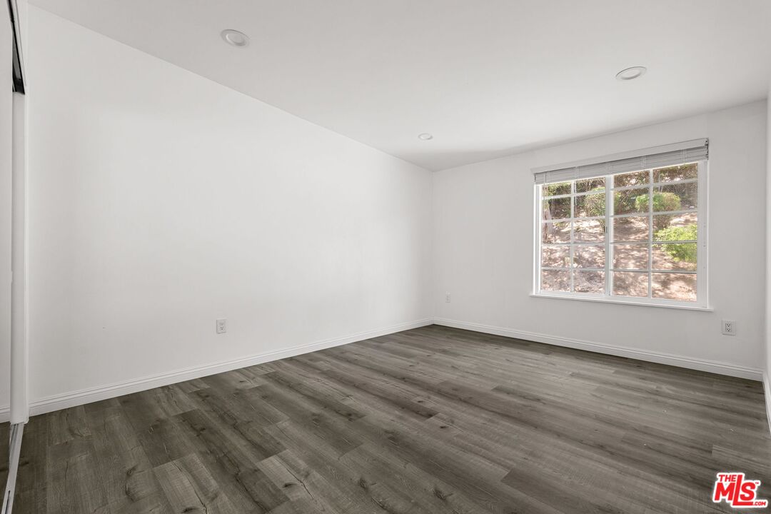 18657 Kirkcolm Lane Porter Ranch, CA 91326 - Photo 15 of 22 an empty room with wooden floor and windows