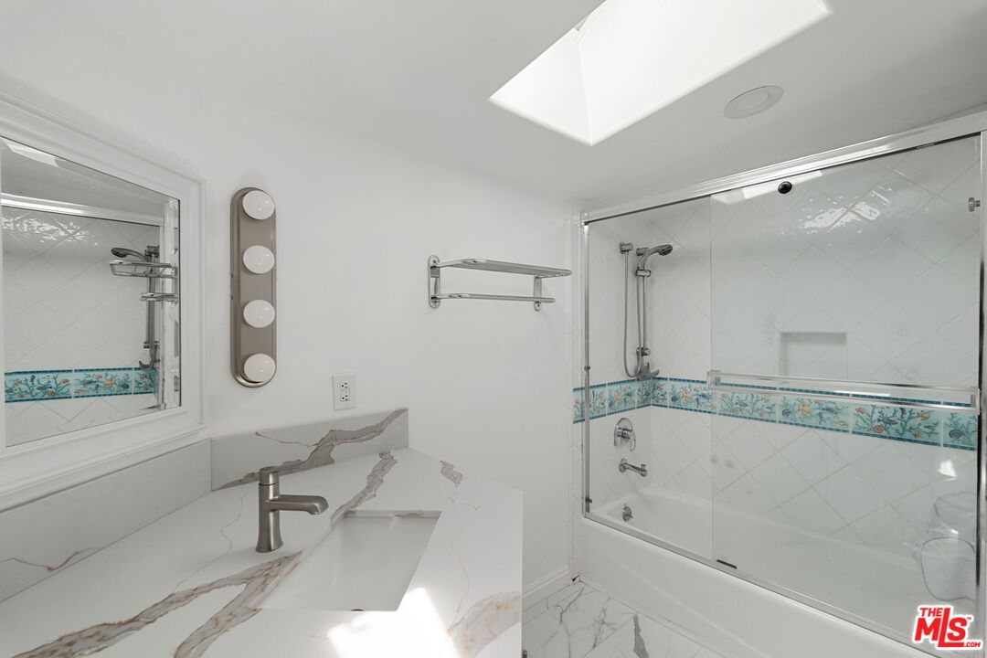 18657 Kirkcolm Lane Porter Ranch, CA 91326 - Photo 18 of 22 a bathroom with a bathtub and a shower
