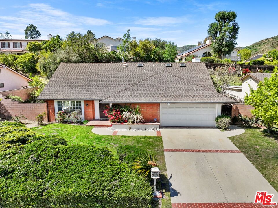 18657 Kirkcolm Lane Porter Ranch, CA 91326 - Photo 22 of 22 an aerial view of a house with table and chairs plants and large tree