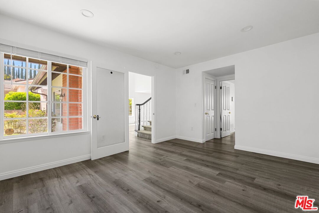 18657 Kirkcolm Lane Porter Ranch, CA 91326 - Photo 9 of 22 an empty room with wooden floor and windows