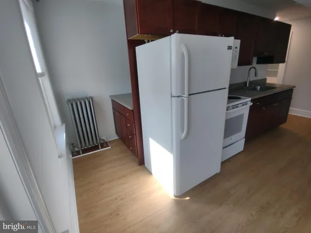 a kitchen with a refrigerator and a stove