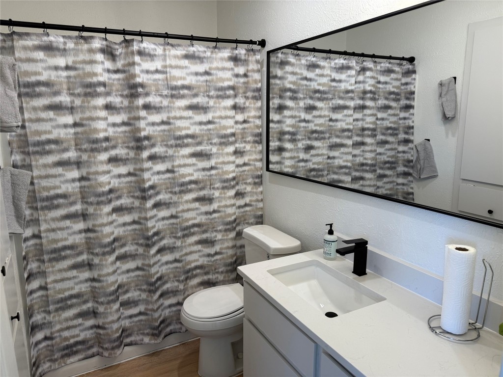 7313 Rhett Place Austin, TX 78744 - Photo 17 of 38 a bathroom with a sink a toilet and shower