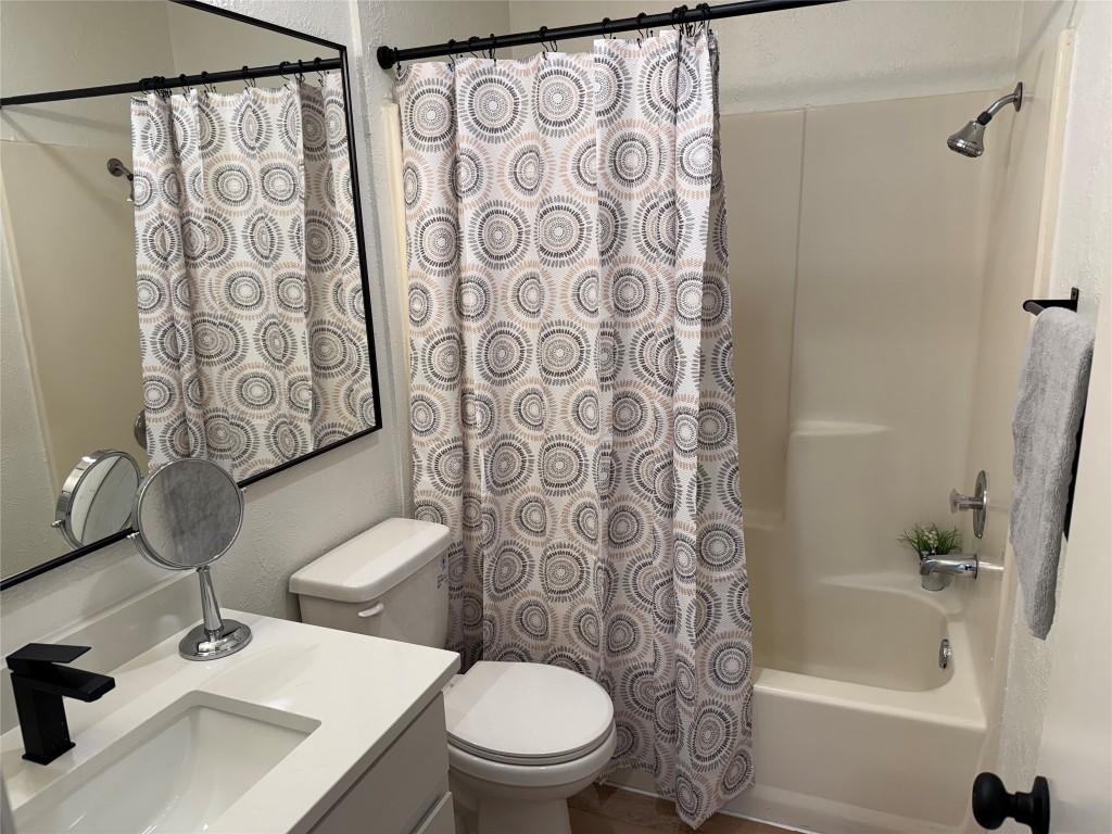 7313 Rhett Place Austin, TX 78744 - Photo 19 of 38 a bathroom with a sink toilet and shower