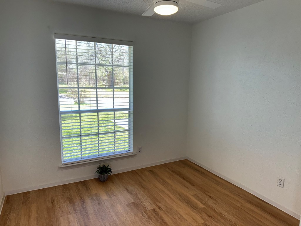 7313 Rhett Place Austin, TX 78744 - Photo 21 of 38 an empty room with wooden floor and windows