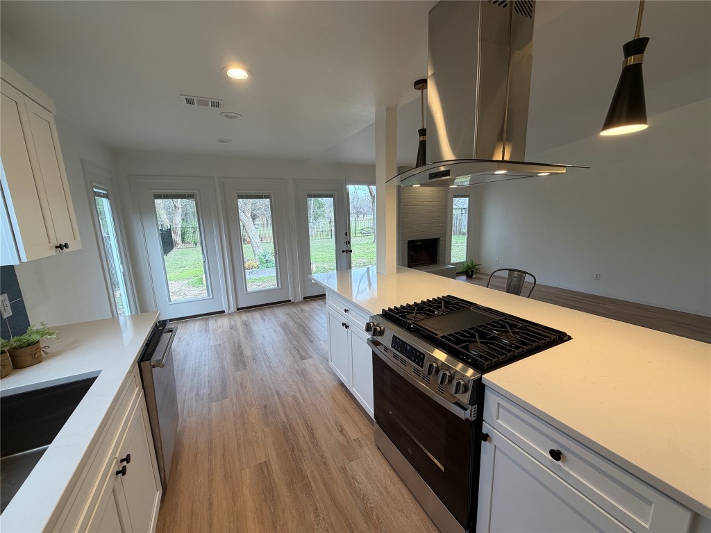 7313 Rhett Place Austin, TX 78744 - Photo 35 of 38 a kitchen with granite countertop a stove and a sink