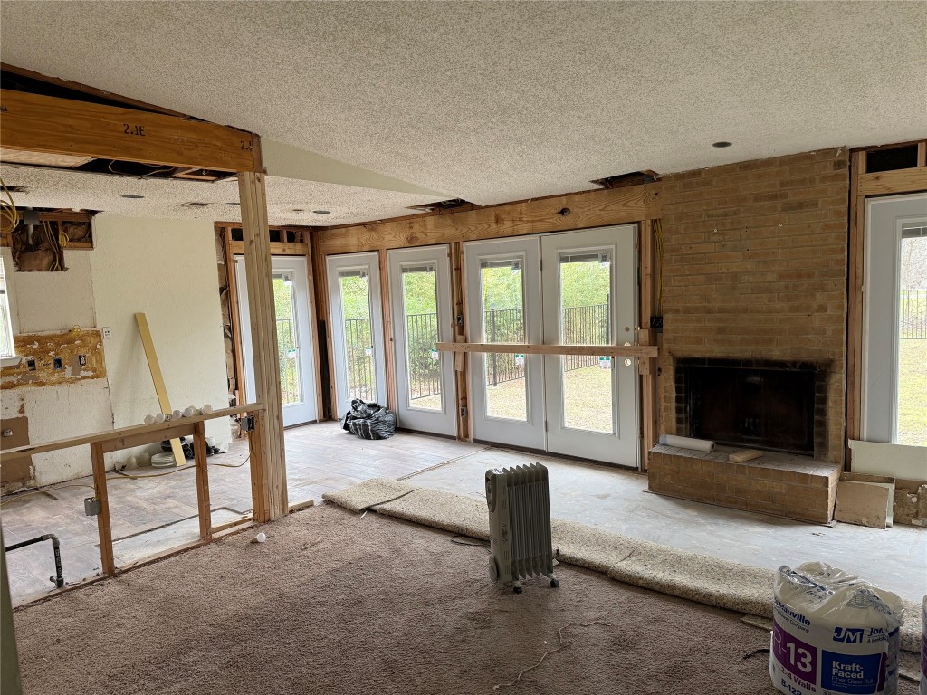 7313 Rhett Place Austin, TX 78744 - Photo 36 of 38 a living room with furniture a flat screen tv and a fireplace