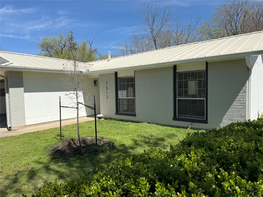 7313 Rhett Place Austin, TX 78744 - Photo 4 of 38 a view of a house with backyard and a garden