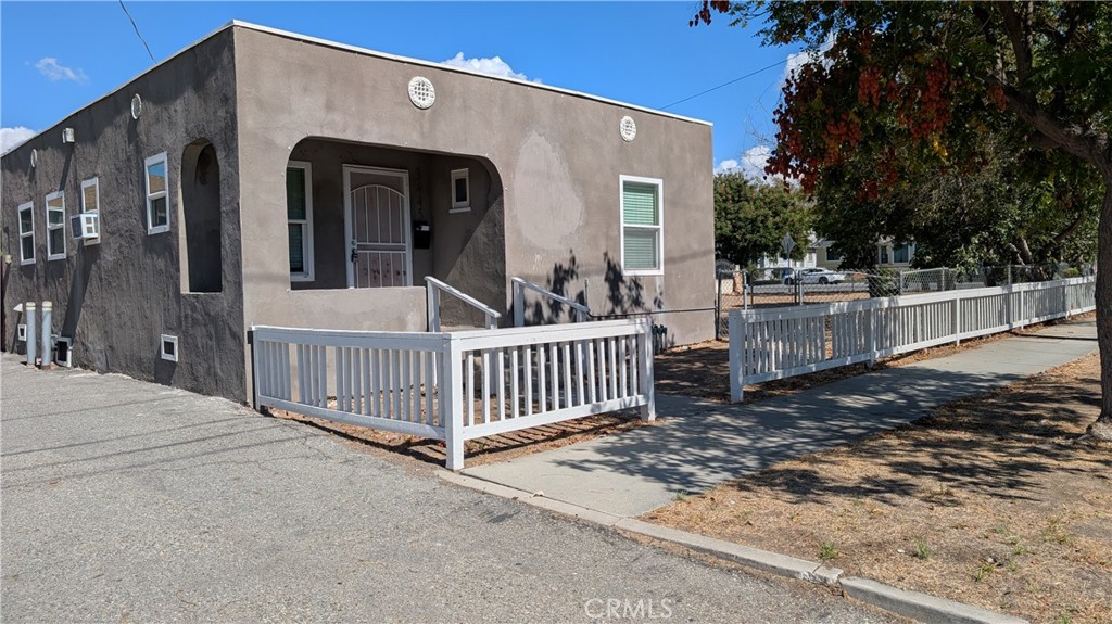 3445 4th Street Riverside, CA 92501 - Photo 1 of 20 a view of a house with a small yard and wooden fence