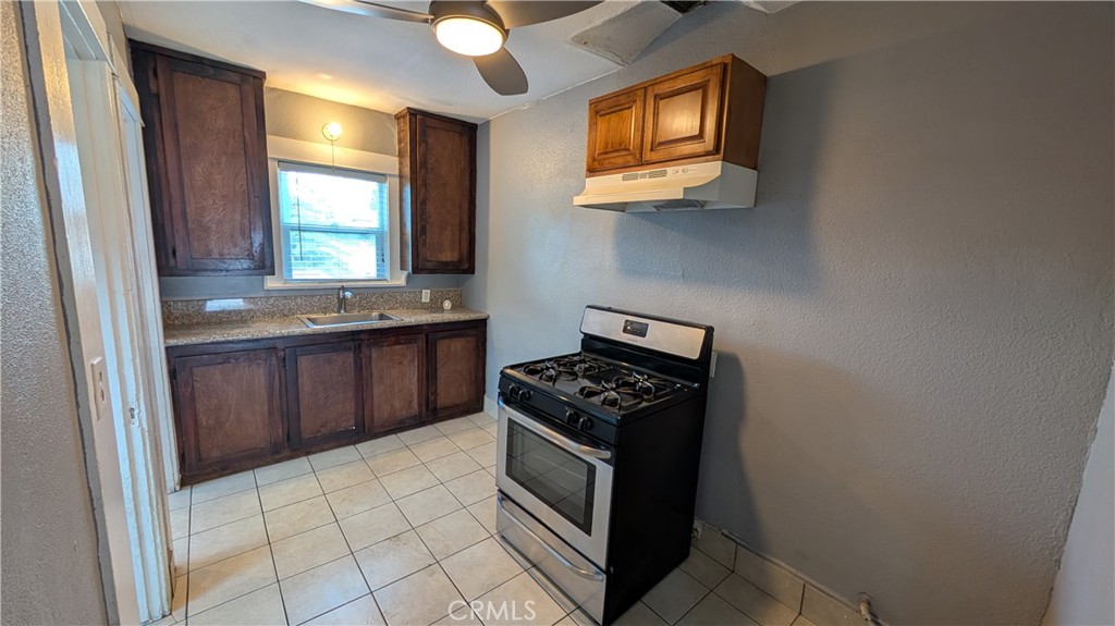 3445 4th Street Riverside, CA 92501 - Photo 6 of 20 a kitchen with stainless steel appliances a stove a sink and a microwave