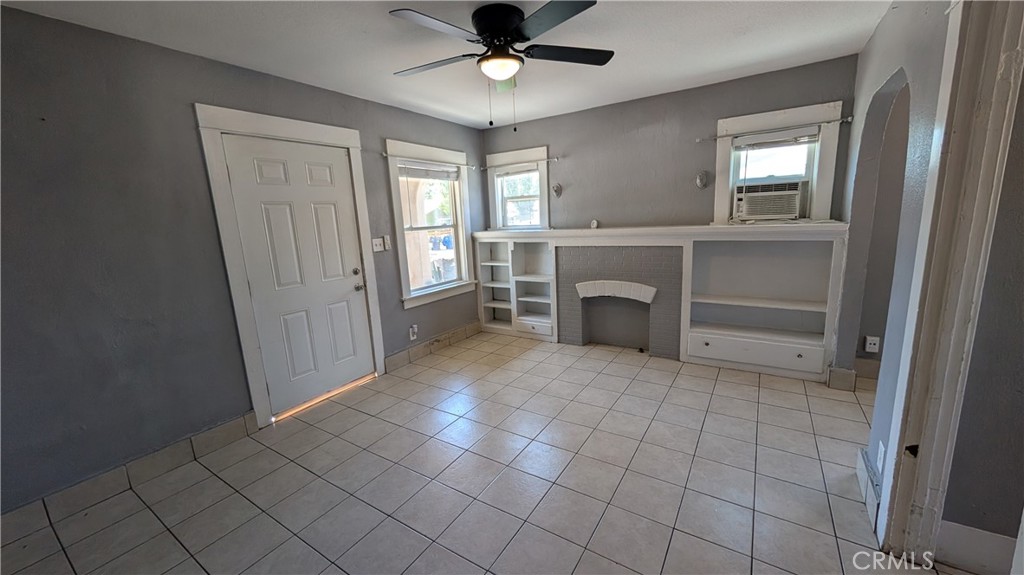 3445 4th Street Riverside, CA 92501 - Photo 9 of 20 a view of an empty room with a fireplace and a window