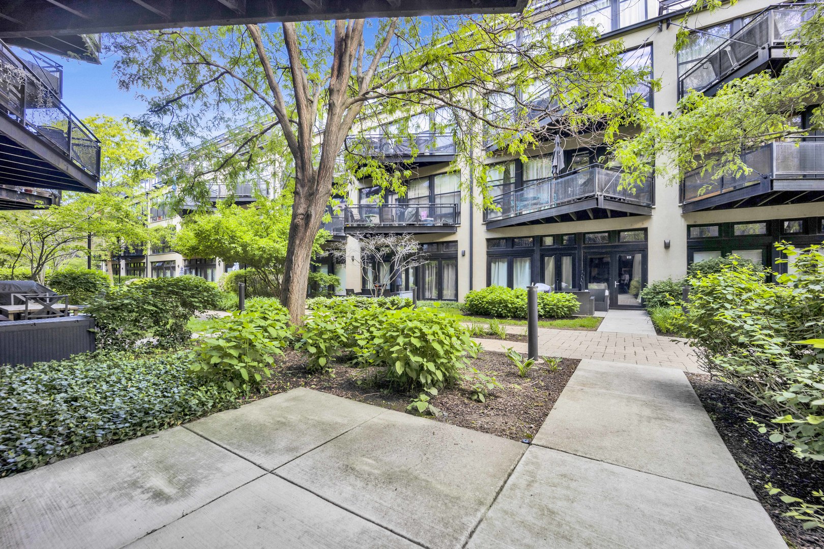 1070 West 15th Street, Unit 112 Chicago, IL 60608 - Photo 17 of 29 a view of a building with a garden