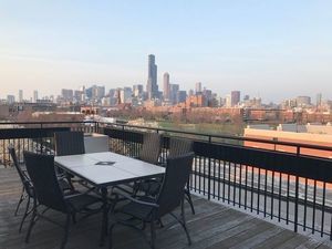 1070 West 15th Street, Unit 112 Chicago, IL 60608 - Photo 19 of 29 a view of a terrace with a table and chairs