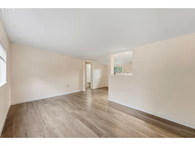 a view of an empty room and wooden floor
