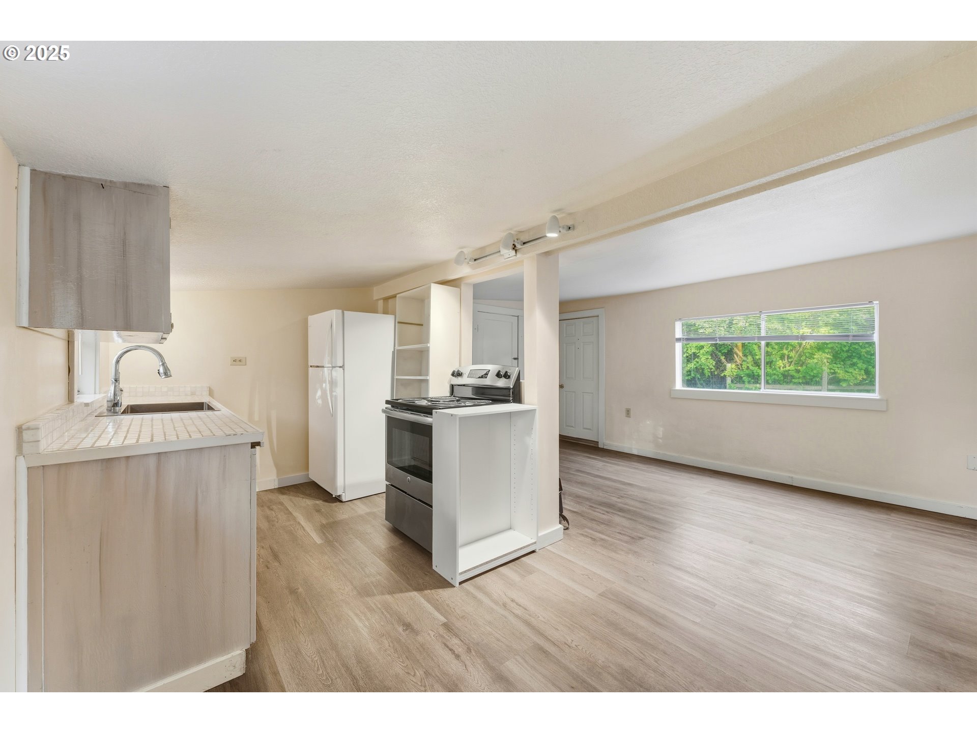 327 Powell Road Milton Freewater, OR 97862 - Photo 16 of 48 a view of a kitchen with a sink wooden floor and a window