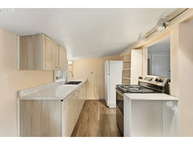 a kitchen with a sink stove and cabinets