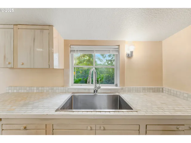 a view of kitchen sink window and cabinets