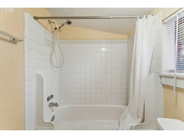 a bathroom with a shower and a bath tub