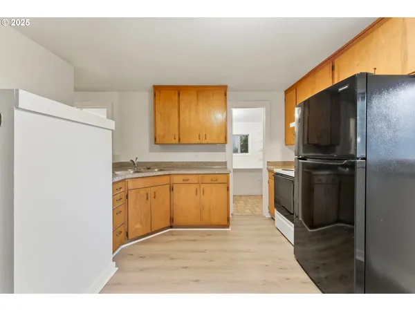 a kitchen with a refrigerator and a sink