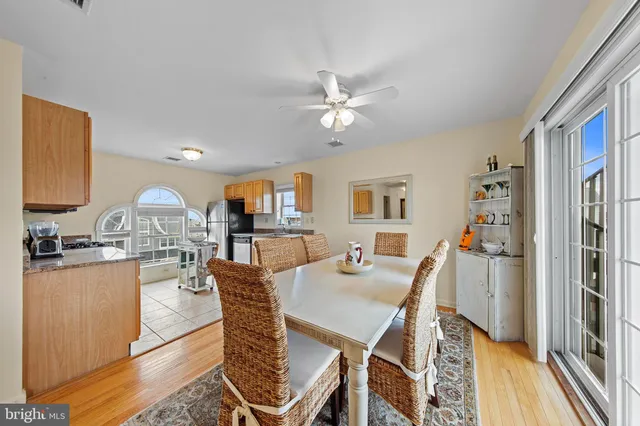 a view of a dining room with furniture a chandelier and wooden floor
