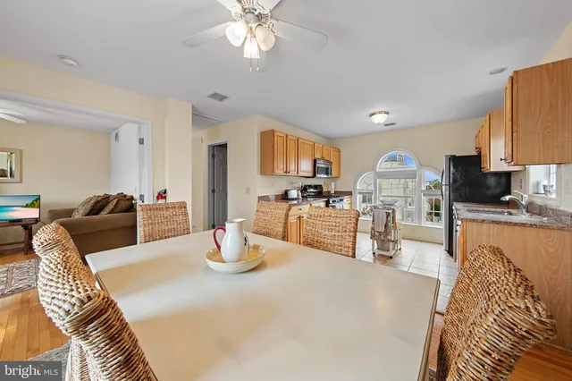 a living room with furniture and a kitchen view