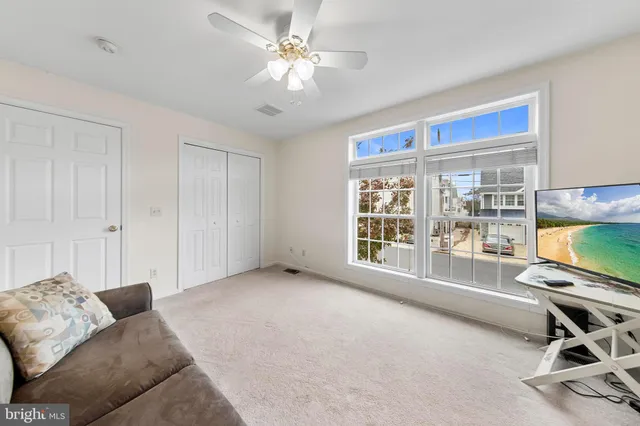 a view of a livingroom with furniture and a flat screen tv