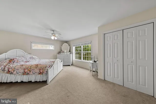 a spacious bedroom with a bed and a window