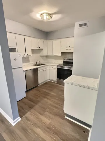 a kitchen with a sink and cabinets