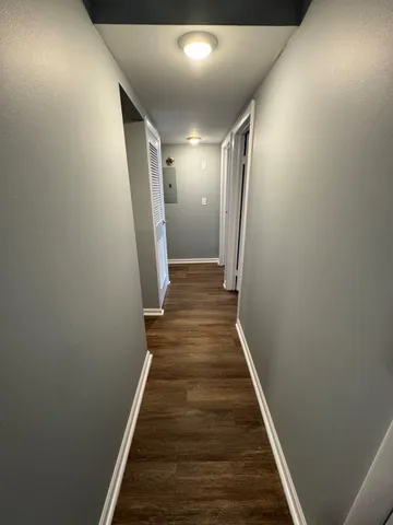 a view of hallway with wooden floor