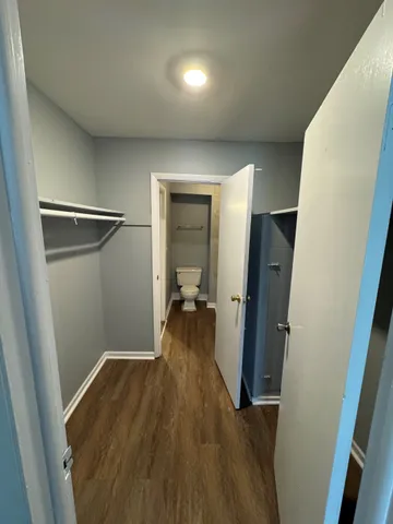 a view of a hallway with wooden floor