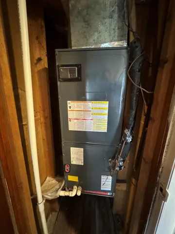 a view of empty room with wooden floor and window