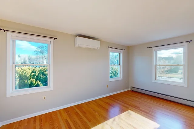a view of a room with wooden floor and window
