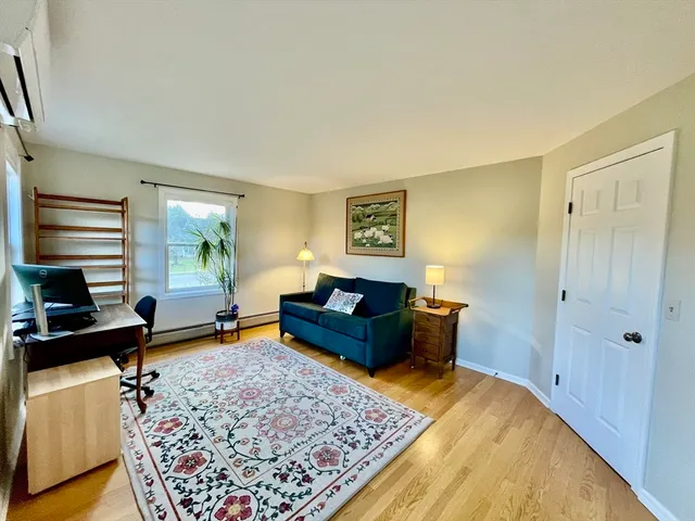 a living room with furniture and a rug