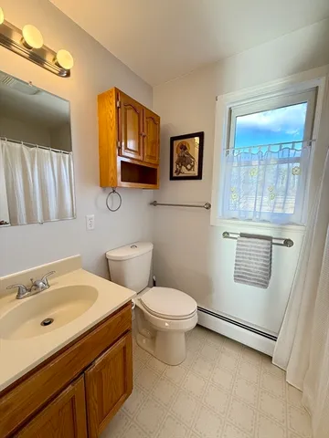 a bathroom with a toilet sink and mirror