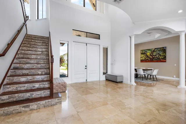 a living room with furniture a fireplace and a chandelier