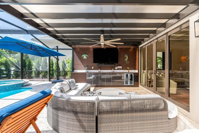 a living room with patio furniture and a garden