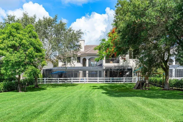 a front view of a house with a yard table and chairs