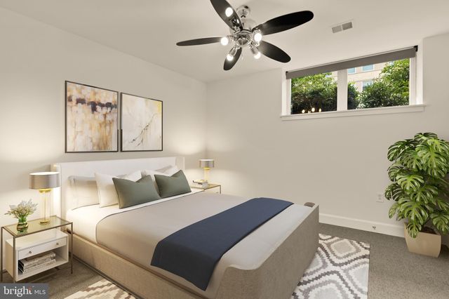 a bedroom with a bed and a potted plant