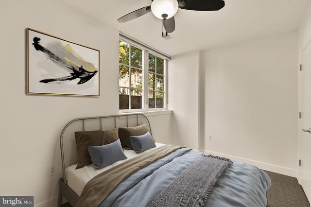 a bedroom with a bed and glass window