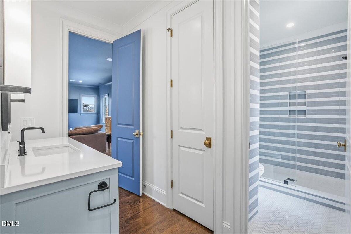 2123 St Marys Street Raleigh, NC 27608 - Photo 43 of 77 a bathroom with a sink and a mirror