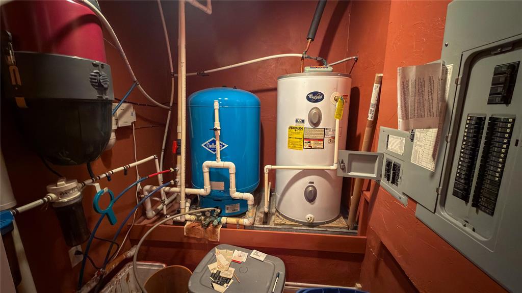 2900 Robinson Road Denton, TX 76210 - Photo 24 of 33 Dedicated utility area featuring a water heater, water filtration system, pressure tank, and electrical panel